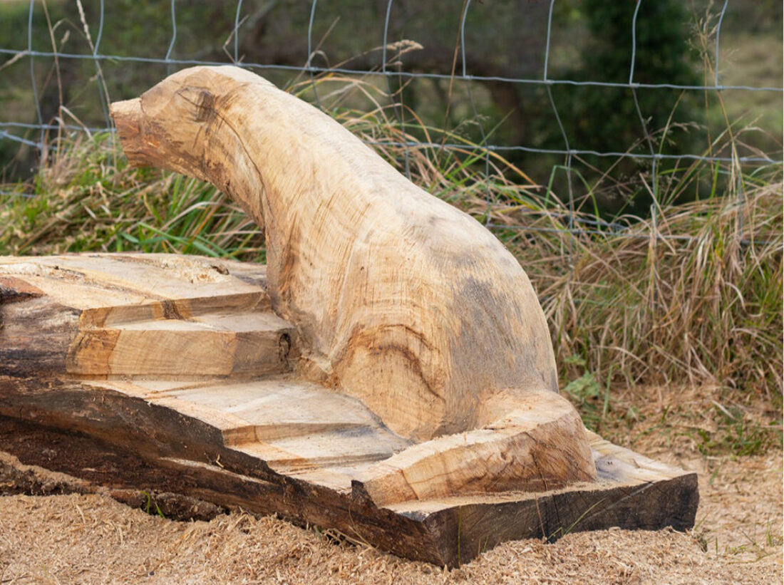 Otter carved into a tree trunk