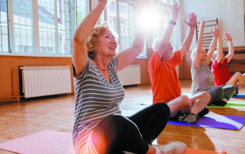 group of cheerful senior citizens having fun together exercising